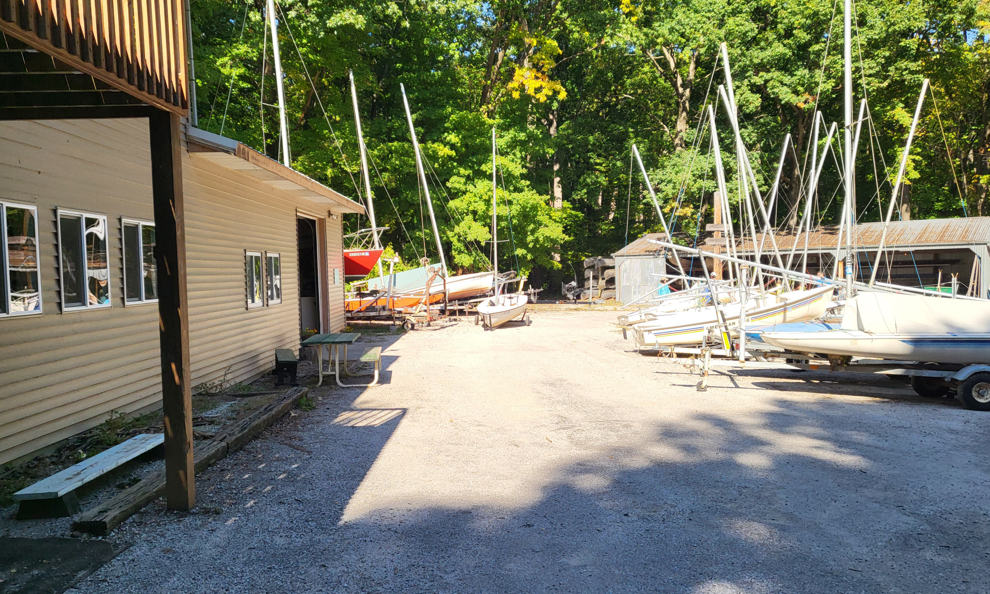 a boatyard with a boat house and small sailboats