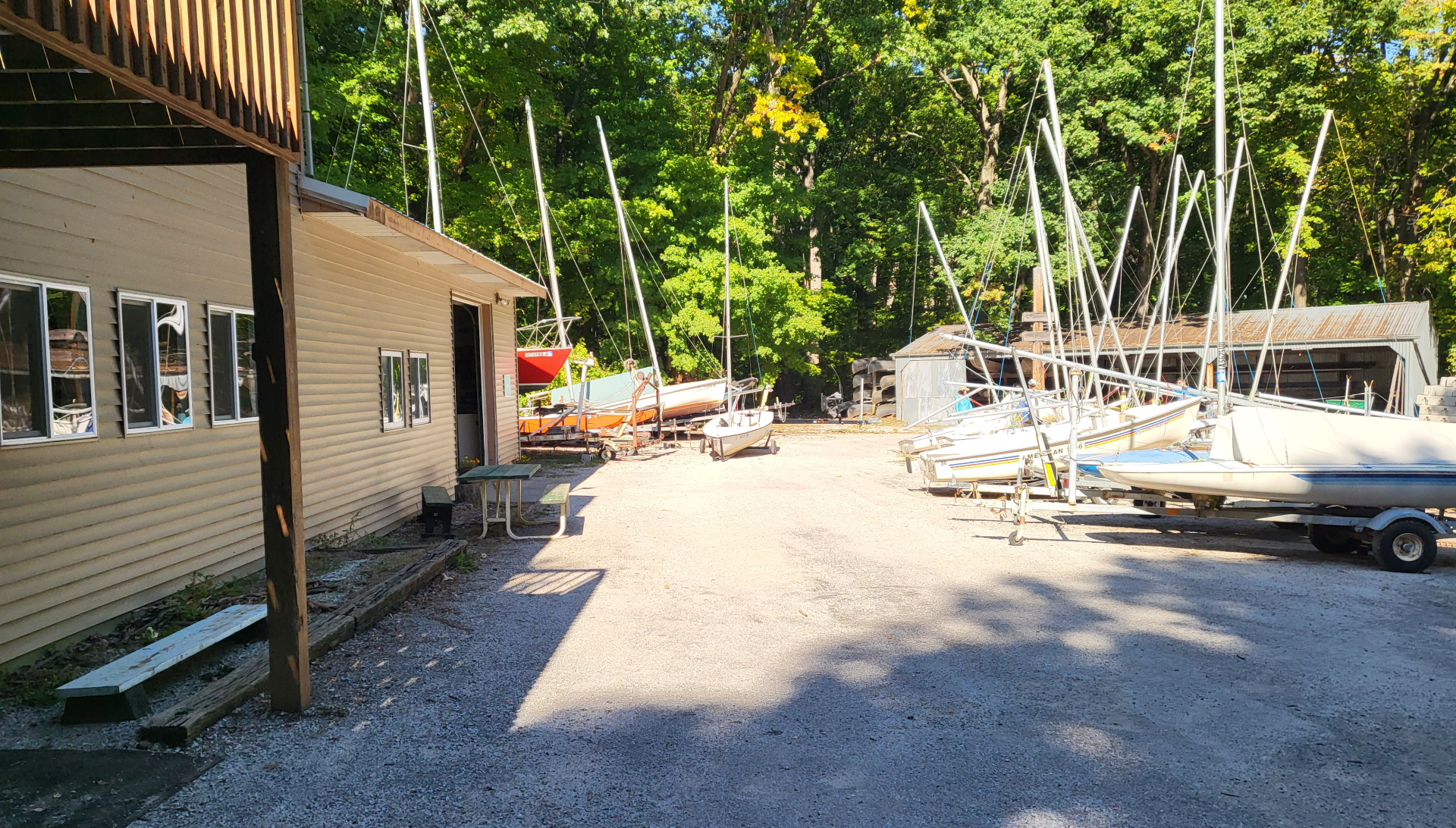 a boatyard with a boat house and small sailboats