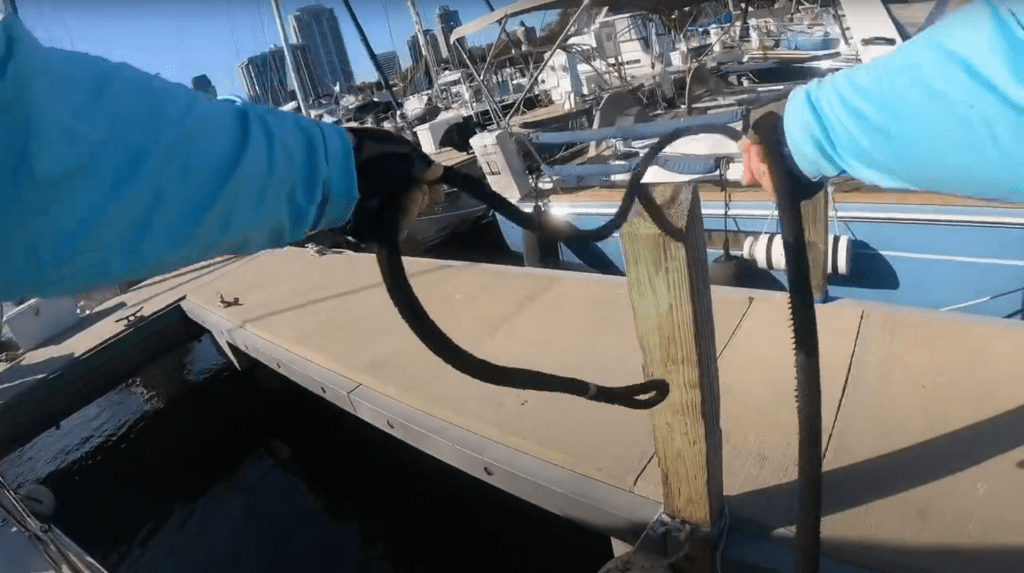 Picture of Becca handling the dock lines, tossing it over a post.