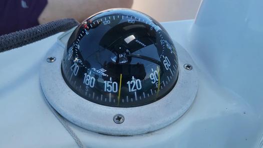 the compass in the cockpit showing a heading of 140 degrees.