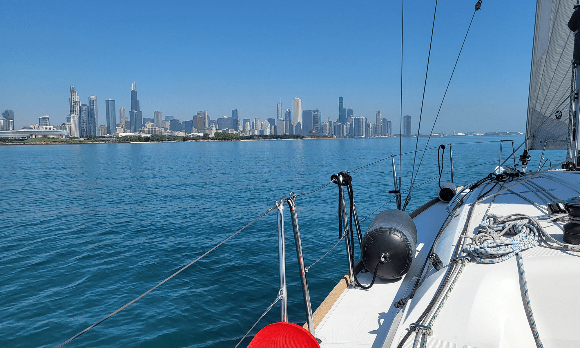 A sailboat on Lake Michigan, with the Chicago skyline in the background
