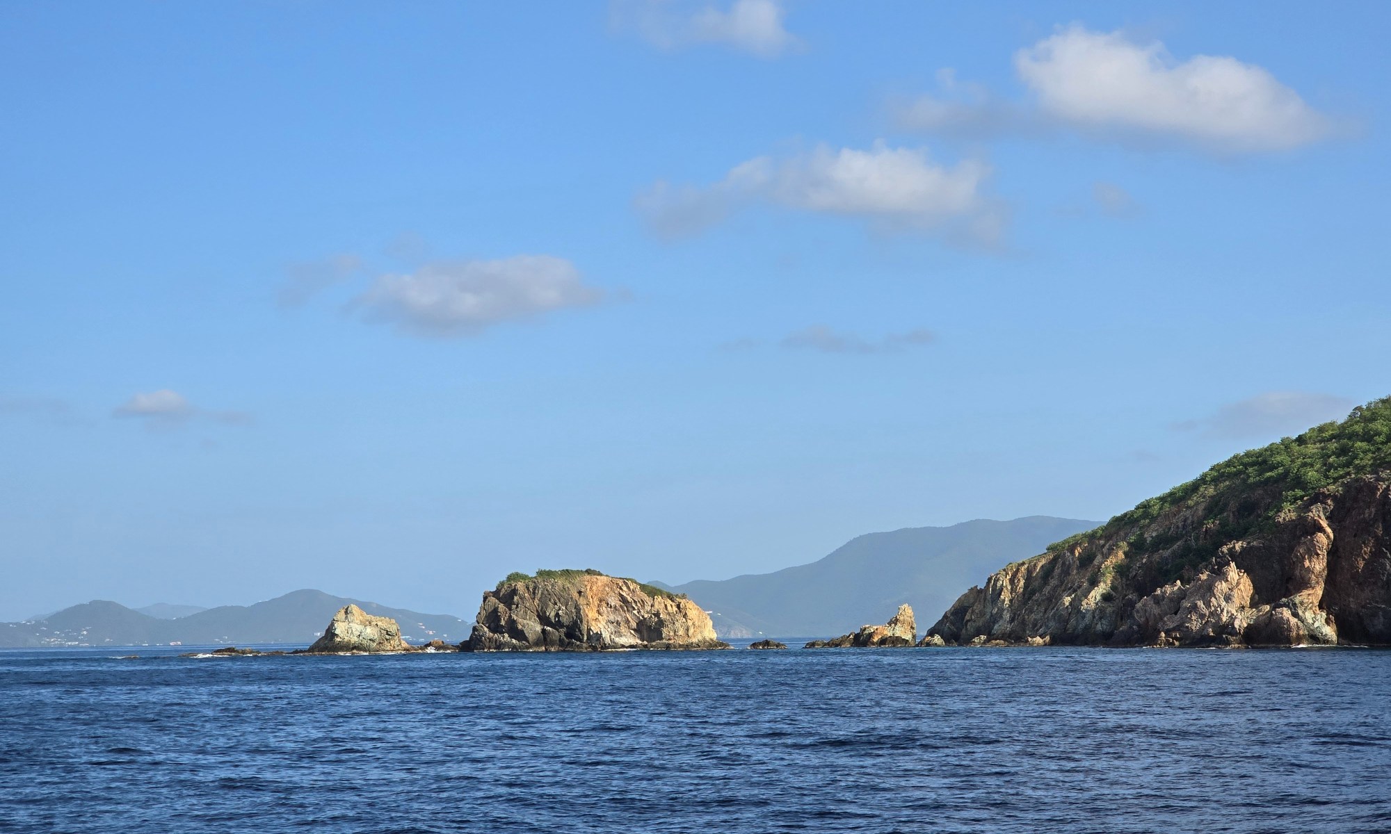 A rocky shoreline and blue skies