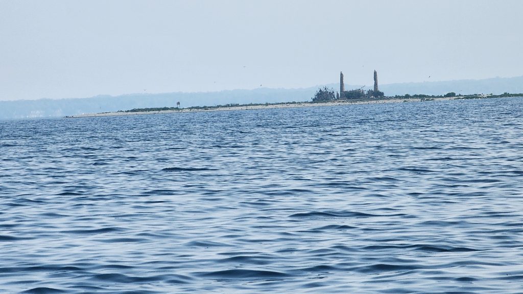 View of Power Island from a sailboat in Lake Michigan
