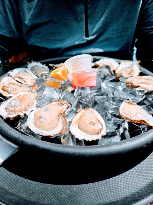A dozen oysters in a platter of ice