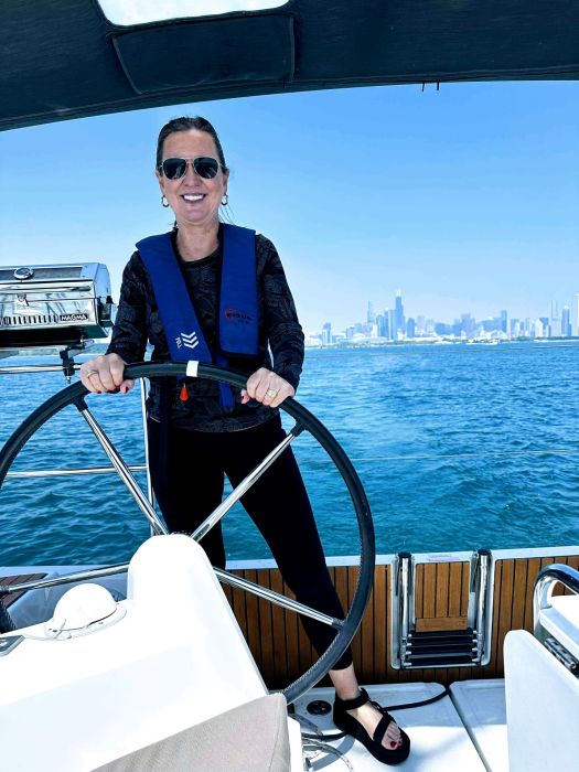 Maria standing at the helm, with the Chicago skyline in the background.