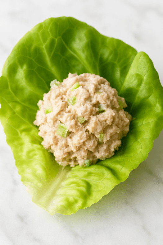 a leaf of butter lettuce with a dollop of tuna salad in it.