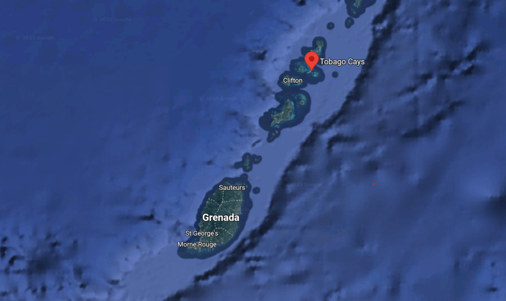 A satellite map showing the chain of islands leading up to Grenada in the southern Caribbean. The map includes the main island of Grenada, with locations like St George's, Saufteures, and Morne Rouge labeled. Further north, the Grenadines islands are visible, with Clifton and Tobago Cays (marked with a red pin) also labeled.